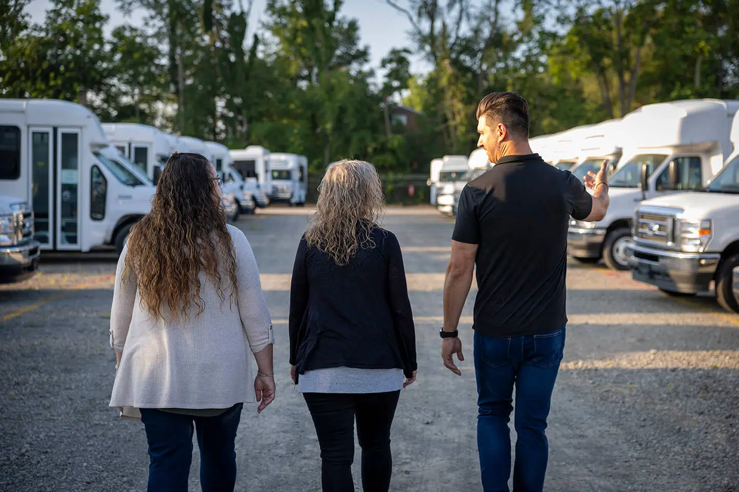 sales person walking and showing vehicles to customers